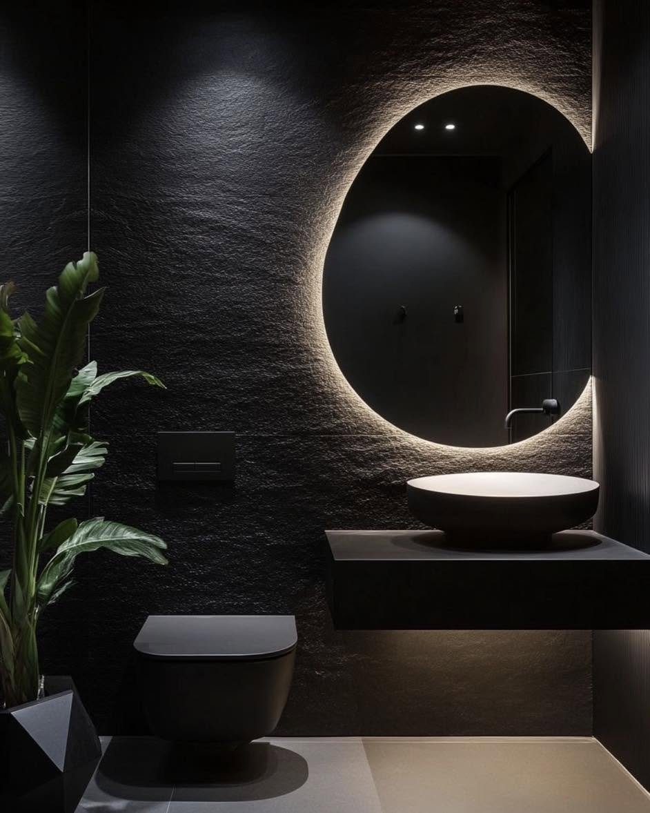 Guest toilet with backlit round mirror and stone wall